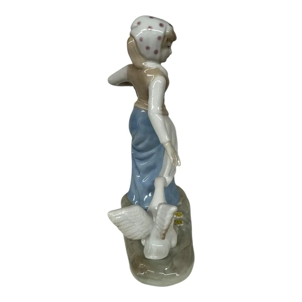 1980 Enesco Fine Porcelain Lady Carrying Eggs with Goose Tugging at Dress‎